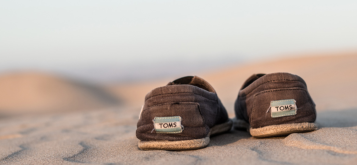 TOMS shoes on sand.